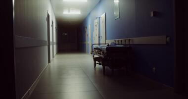 A hospital gurney left after transporting an urgent patient stands in an empty corridor of the hospital. in 4k, red komodo video