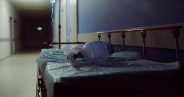 A hospital gurney with an oxygen bottle left on it sits in an empty hospital corridor after transporting an urgent patient. in 4k, red komodo video