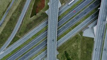 View of the road junction with cars passing along it, shooting from a drone. Multi-level road, top view, filming from a quadrocopter. video