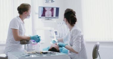 Dental examination of the patient's teeth using a micro camera with an image displayed on the screen of a dentist. Modern dentistry. in 4k, red komodo video