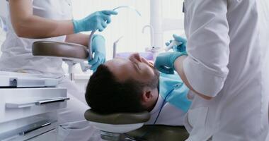 Dental examination of the patient's teeth using a micro camera with a flashlight, displaying the image on the screen of the dentist for detailed examination. Modern dentistry. in 4k, red komodo video