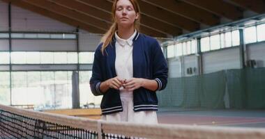Toss a coin to determine the order before playing tennis. Determining which player will throw the ball first, a young woman referee tosses a coin video