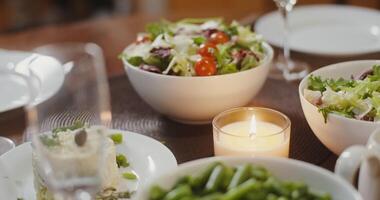 A festive richly set table with many different mouth-watering dishes. Close-up video