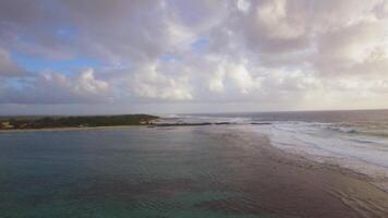 Aerial view of water line of seas that do not mix against blue sky with clouds, Mauritius Island video