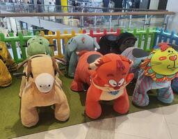 A group of stuffed animals in a store photo