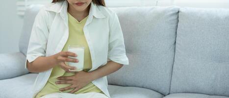 Sick sad unhealthy ill allergic woman, runny stuffy sore nose suffer from intolerance allergy trigger symptoms. abdominal pain, allergens, nut protein, death, food allergy. photo