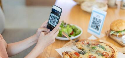 smartphone to scan QR code to pay in cafe restaurant with a digital payment without cash. Choose menu and order accumulate discount. E wallet, technology, pay online, credit card, bank app. photo