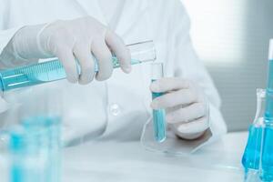 Scientist analyze biochemical samples in advanced scientific laboratory. Medical professional use dropper mix microbiological developmental of viral. Biotechnology research in science photo