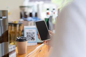 Woman use smartphone to scan QR code to pay in cafe restaurant with a digital payment without cash. Choose menu and order accumulate discount. E wallet, technology, pay online, credit card. photo
