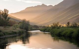 A river runs through a valley surrounded by mountains photo