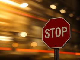 A Stop sign isolated on blurred bokeh effect with contrasting chiaroscuro lighting and long exposure time photo