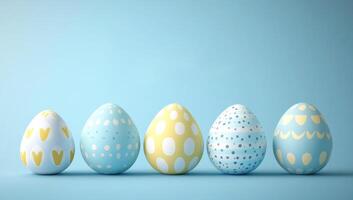 Five decorated easter eggs standing on a light blue surface, creating a festive and colorful easter scene photo