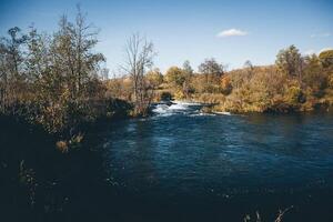 A river with trees and water in the background photo