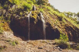 A waterfall in the mountains photo