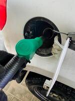 Refueling your vehicle at a gas station that features a green nozzle is a great way to choose ecofriendly options, thereby promoting sustainable energy practices effectively photo