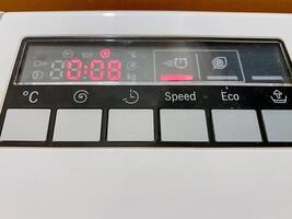 This image features a detailed close up of a digital display panel located on a modern dishwasher, showcasing its electronic interface and various settings options for user convenience photo
