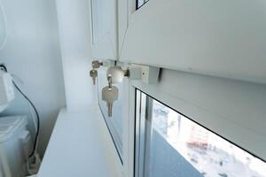 A detailed closeup view of a window that has various keys placed on it, creating an interesting composition and visual appeal, showcasing the interaction of light and shadows photo