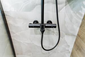 This is a close up view of a shower head that can be found in a bathroom, showcasing its design and features. It is an essential bathroom fixture for plumbing and cleanliness photo