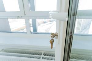 This closeup photograph showcases a beautifully crafted window with a key in the lock, highlighting the exquisite craftsmanship and intricate details of the sash window design photo