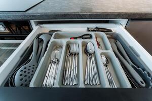 Imagine a kitchen drawer that is overflowing with a variety of silverware and utensils, creating a fantastic storage solution for all of your essential cooking tools and equipment photo