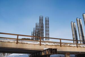 A large bridge is currently under construction, prominently featuring a beautiful blue sky in the background, creating a striking visual contrast that highlights the engineering marvel photo