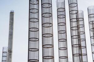 A long row of shiny metal pipes has been perfectly aligned against a stunning vibrant blue sky, creating a striking visual contrast that beautifully catches the eye and captivates attention photo