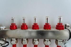 This image features a detailed close up of a stainless steel pipe that has bright red caps securely fitted on both ends, showcasing its industrial design and functionality photo