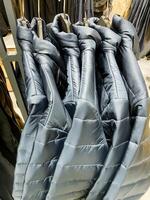 A diverse collection of jackets hangs neatly in a retail store, showcasing different styles and materials for customers to explore and choose according to their preferences photo