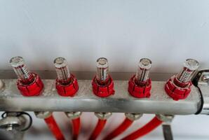 A detailed, closeup inspection reveals a pipe featuring striking vivid red caps located at both ends, which emphasizes its sleek, cylindrical shape and distinctive material composition photo