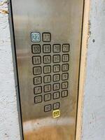 The image features a detailed closeup of an elevator button that prominently displays the number 22 on it, indicating the specific floor it represents in the buildings layout photo