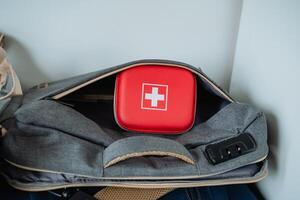 Inside a highly durable and sturdy bag, you will find a vibrant red box that prominently displays a striking cross, making it perfect for a variety of practical uses and purposes photo
