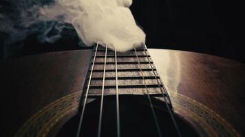 Instrument Classic guitar in smoke with a single string Missing video