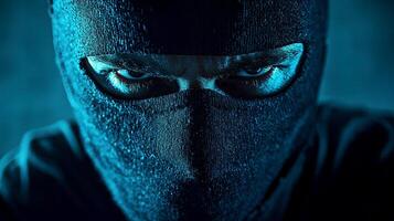 man wearing a black mask and a suit on dark blue isolated background. photo