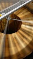 Centrifuge machine spinning the wooden frames to remove organic honey. Electric machine quickly rotating close up. Top view. Vertical video