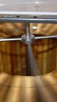 Electric machine for honey removal rotating frames. Close up. Honey extractor working with opened lid. Top view. Vertical video