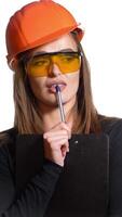 Young woman construction worker in hard hat on a white background. Attractive woman builder with notepad in hand makes the decision Vertical video