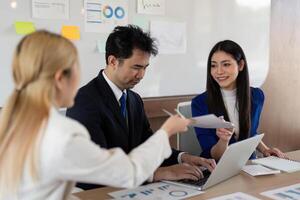 Team of professionals brainstorming in an office, reviewing financial data and strategizing for success. photo