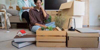 LGBTQ couple unpacking boxes and arranging their new home, highlighting teamwork and love. photo