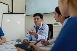 Medical professionals in a meeting discussing patient analysis and healthcare strategies. photo