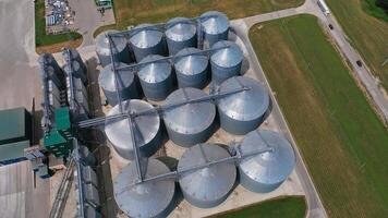 Huge tanks for processing and storage of wheat grain. Harvesting, processing and storage elevator for the crops. Aerial view. video