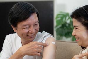 Elderly couple sharing a joyful moment after vaccination, showcasing support and companionship. photo
