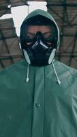 Portrait of a person in gas mask in destroyed building. Technogenic catastrophe. Post apocalyptic world. Survivor after nuclear chemical war. Vertical video