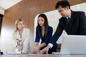Team of professionals analyzing financial reports and charts during a strategic meeting. photo