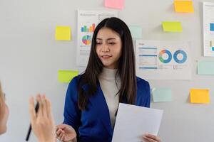 Business analyst presenting budget analysis and project planning in a team meeting, discussing strategies and visual data. photo