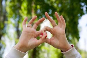 Two hands making a sign with their fingers photo