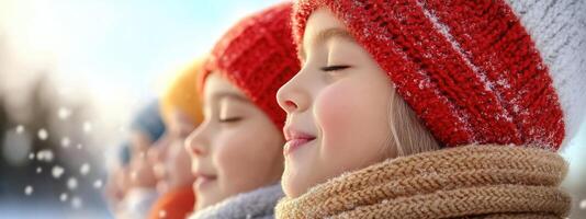 Three children smile contentedly as they play in the falling snow. Their vibrant winter attire and the soft sparkle of snowflakes create a joyful atmosphere on a bright, cold day photo