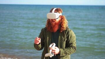 Man with red beard wearing virtual reality headset and holding VR controller video