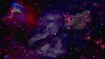 Stars fly past the viewer against a backdrop of clouds and gas in space video