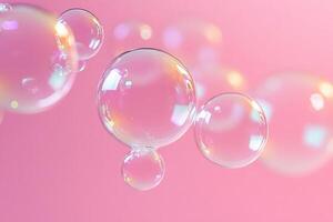 Transparent Soap Bubbles on a Pastel Pink Background for Vibrant and Creative Design Projects photo