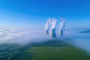 Cooling towers of nuclear power plant over the gog, aerial view photo